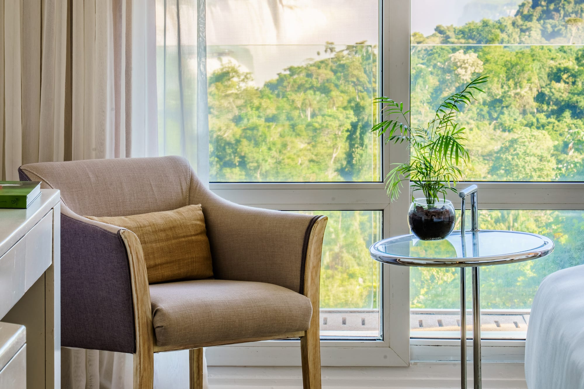 a room with a window and a chair and a table