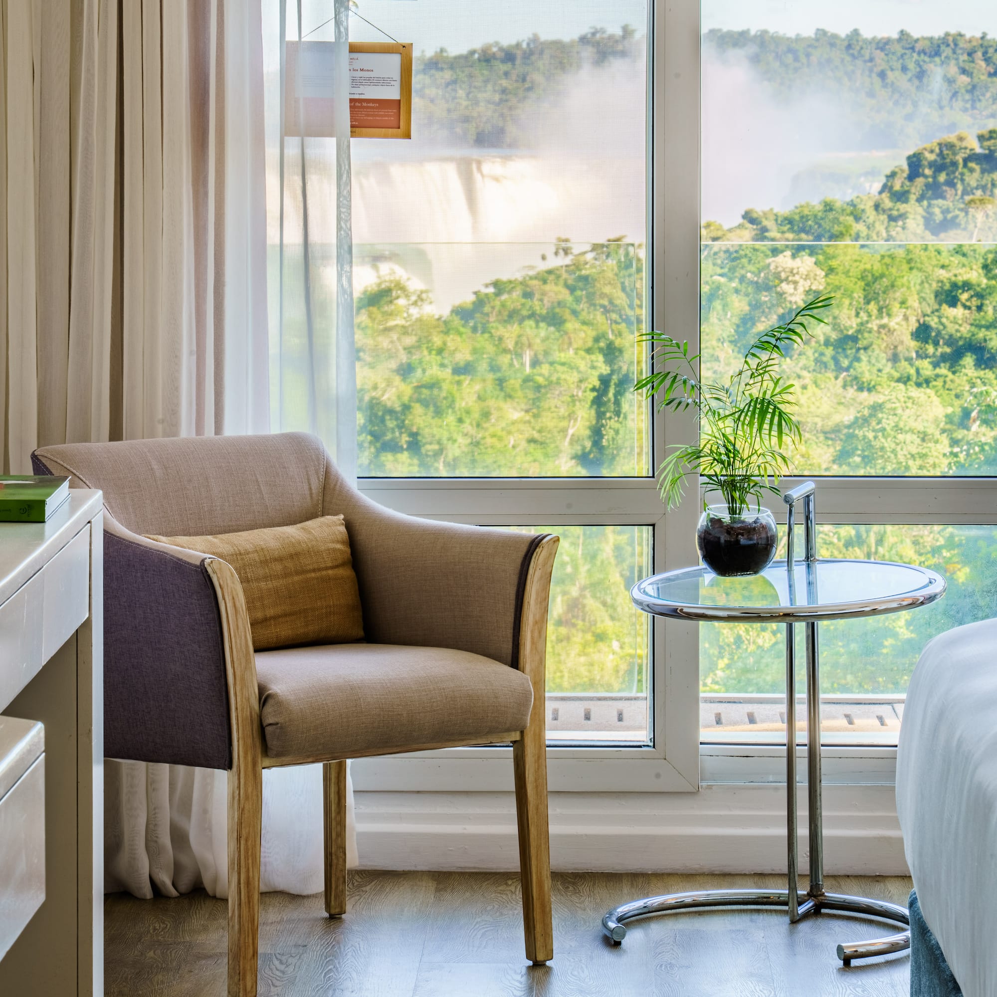 a room with a window and a chair and a table