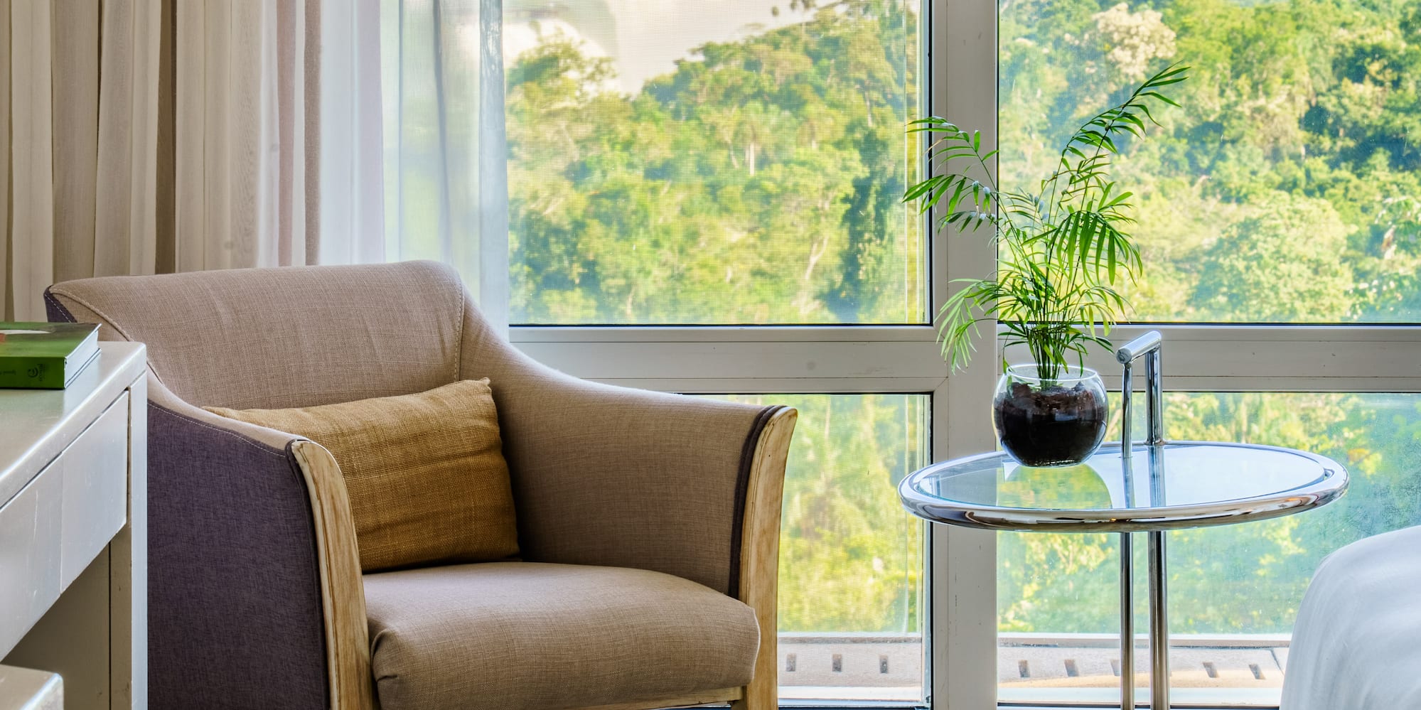 a room with a window and a chair and a table