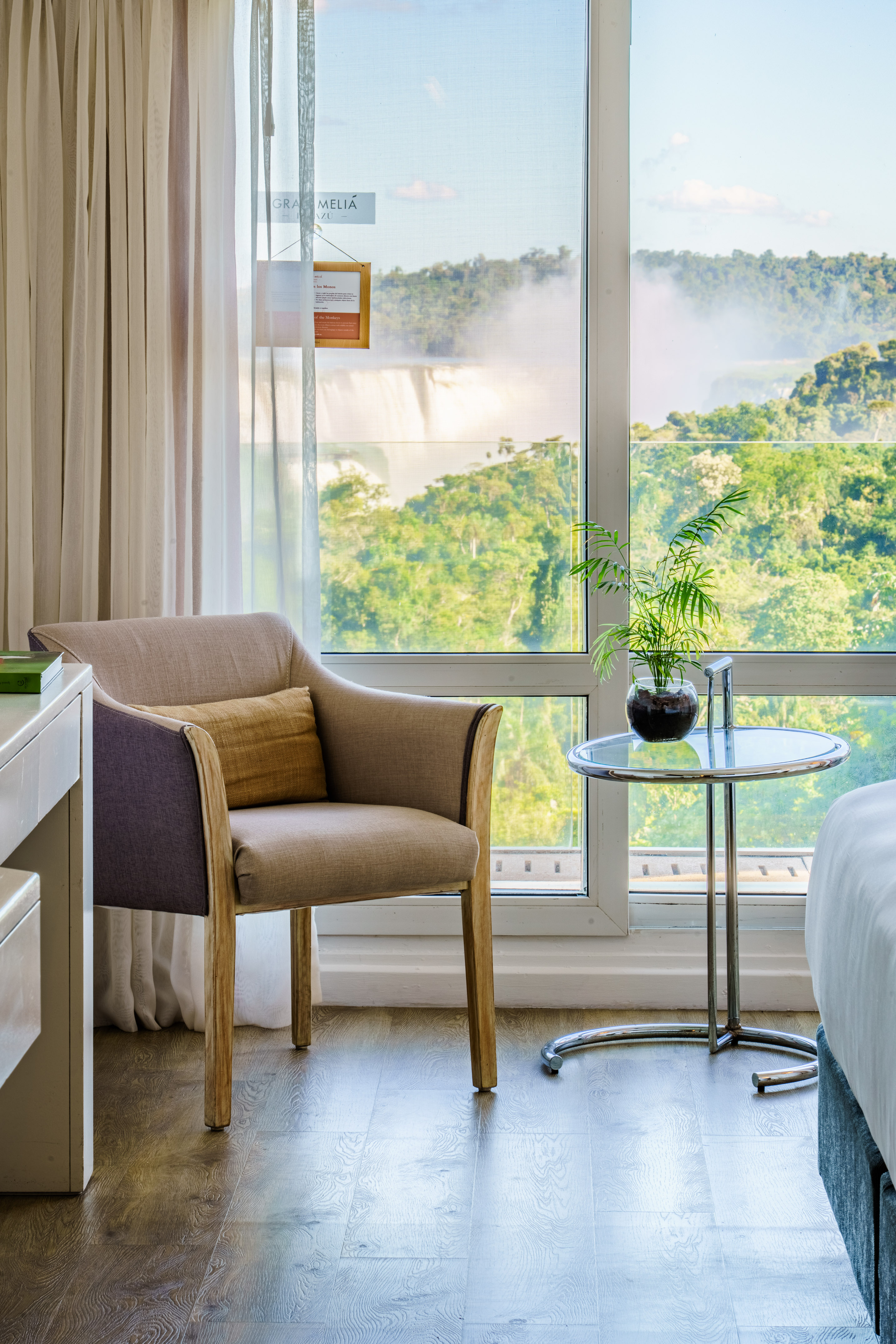 a room with a window and a chair and a table