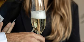 a man holding a glass of champagne
