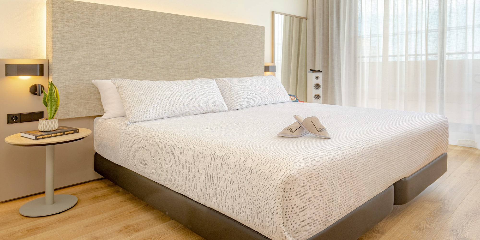 a bed with a headboard and a pair of shoes on it