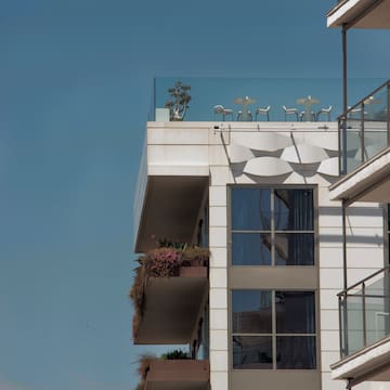 a balcony with chairs and tables on top of it