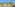 Tropical resort with swimming pools, palm trees, beach, and ocean view.