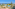 Resort with oceanfront view, swimming pools, palm trees, and sunny terrace.