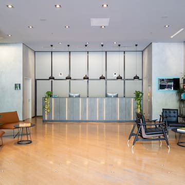 a lobby with a reception desk and chairs