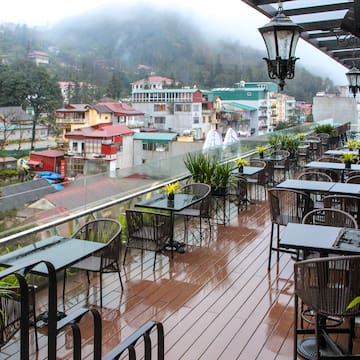 a restaurant with tables and chairs on a deck