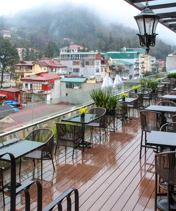 a restaurant with tables and chairs on a deck