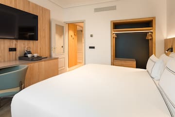 a room with a bed and a tv