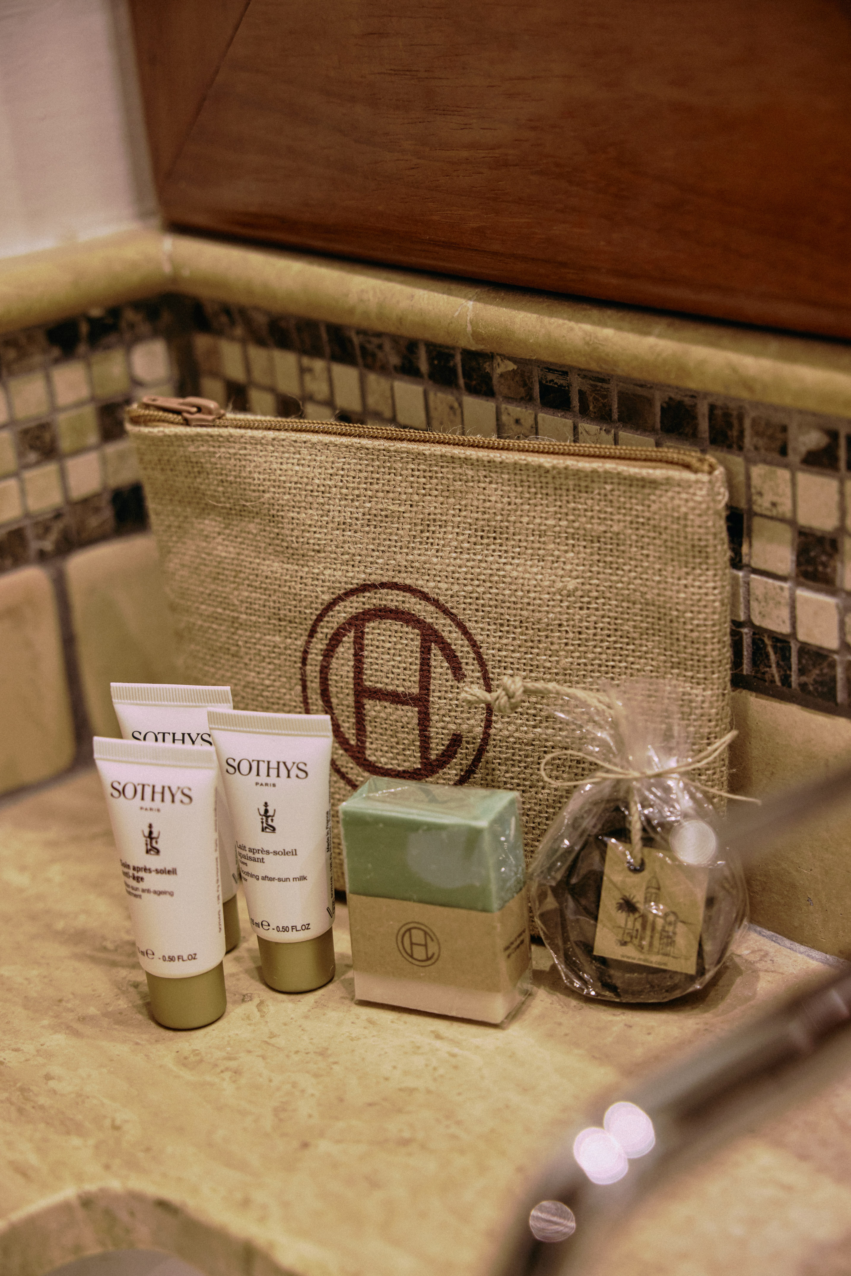 Sothys Paris toiletries: after-sun milk, cream, soaps, and burlap cosmetic bag.