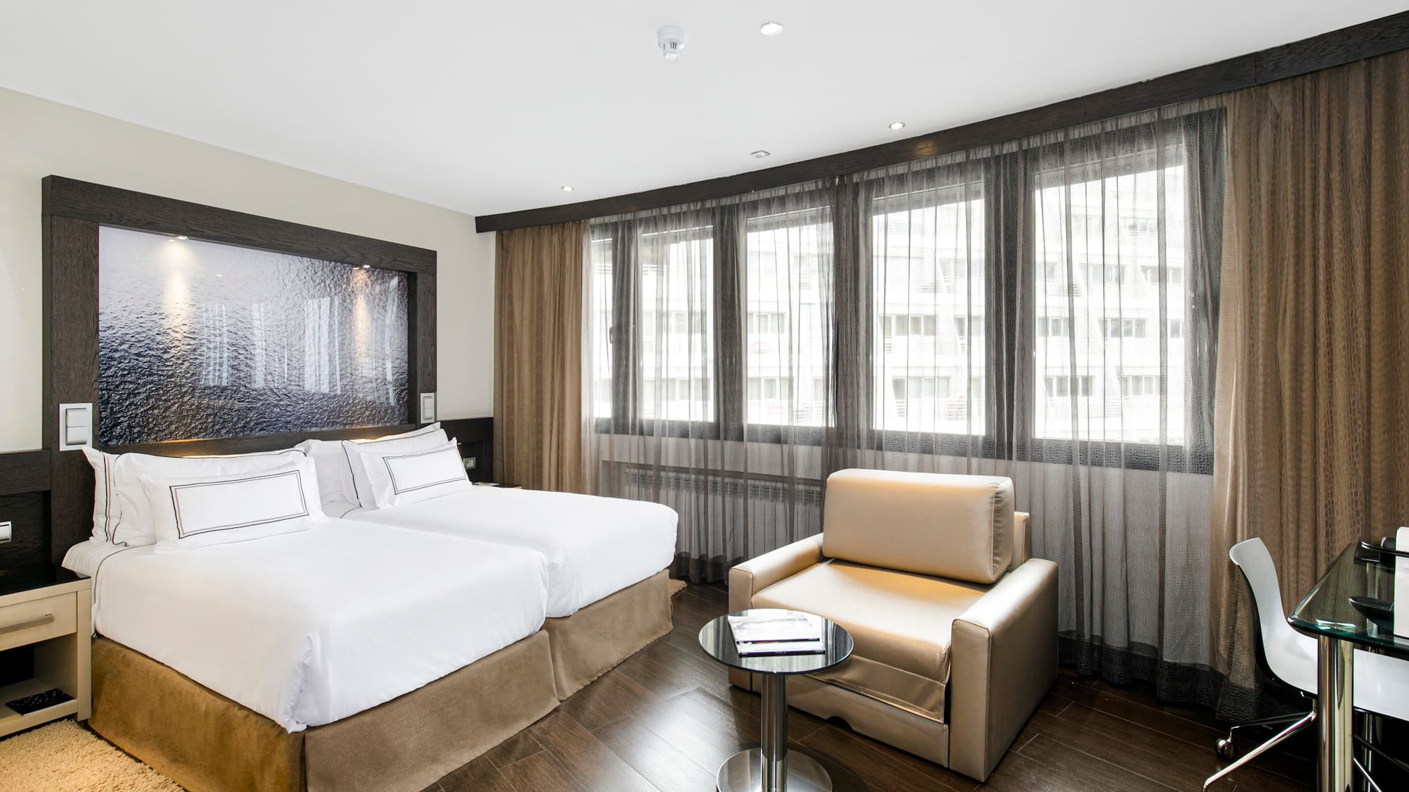 a room with two beds and a table