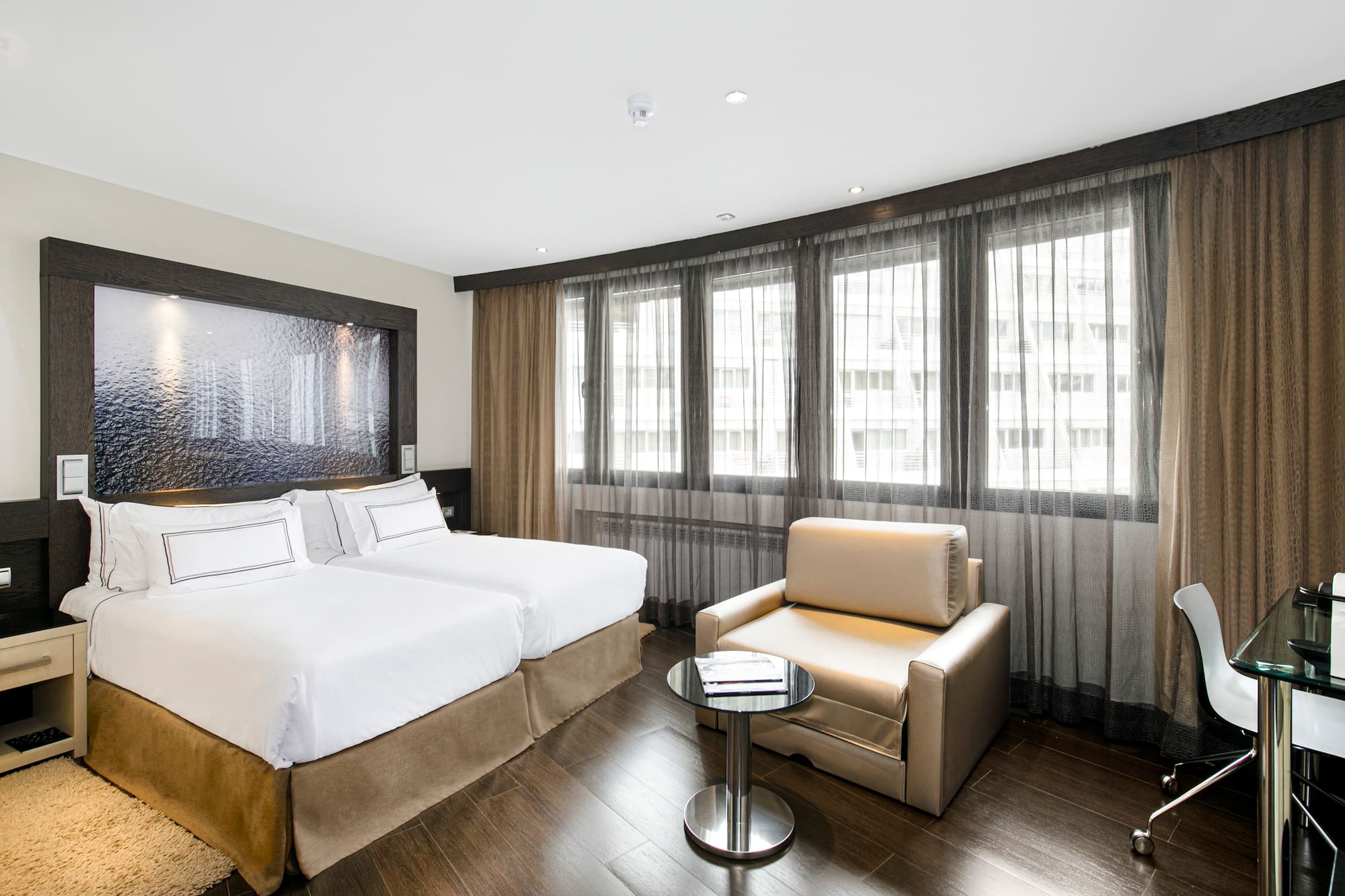 a room with two beds and a table