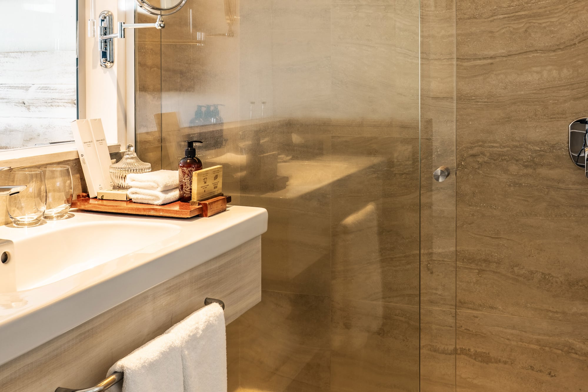 a bathroom with a glass shower door