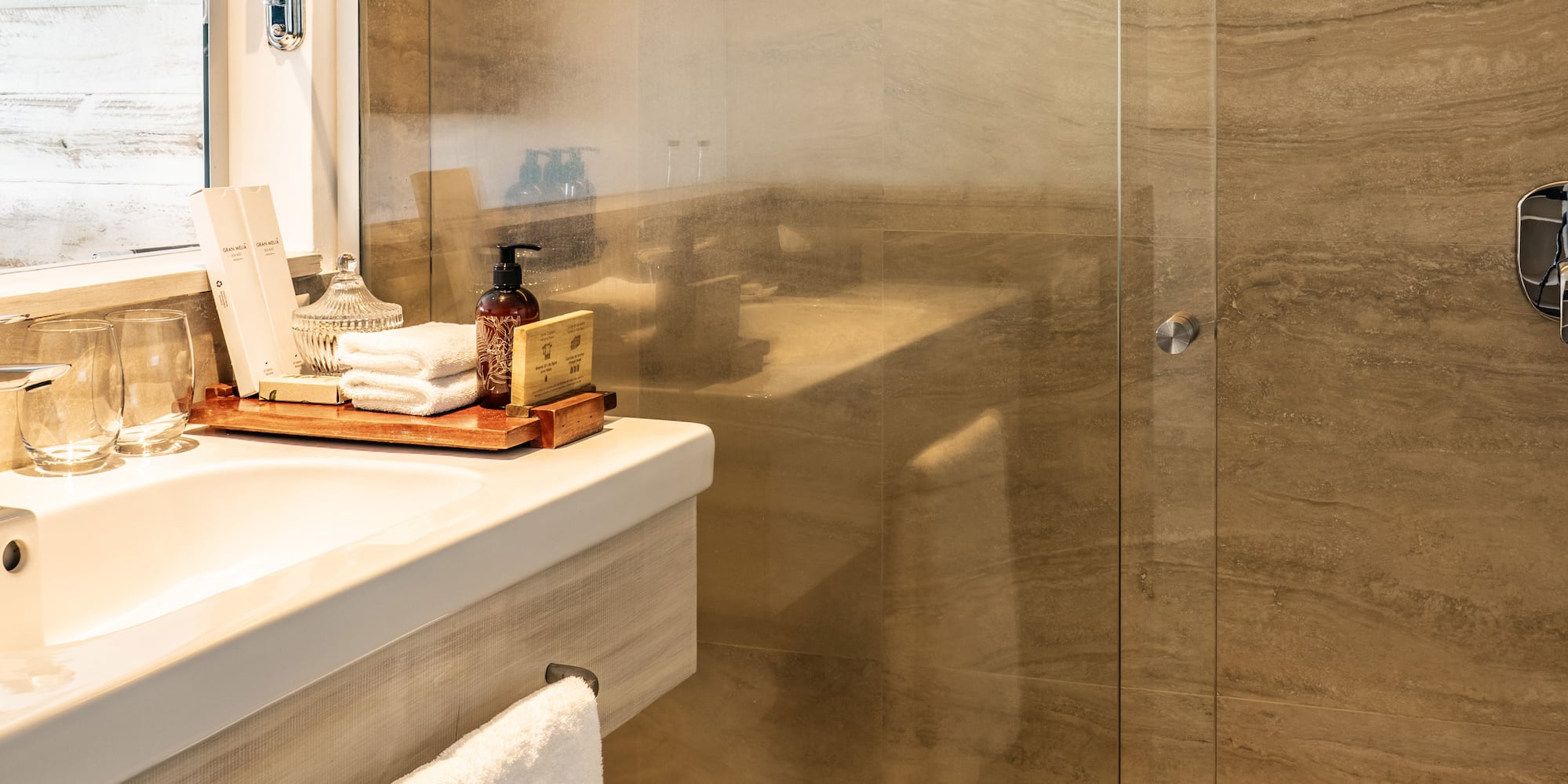 a bathroom with a glass shower door