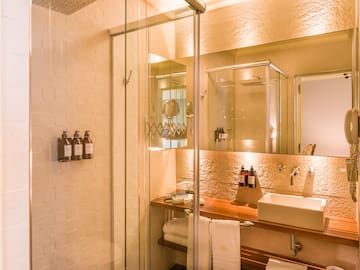 a bathroom with a glass shower door