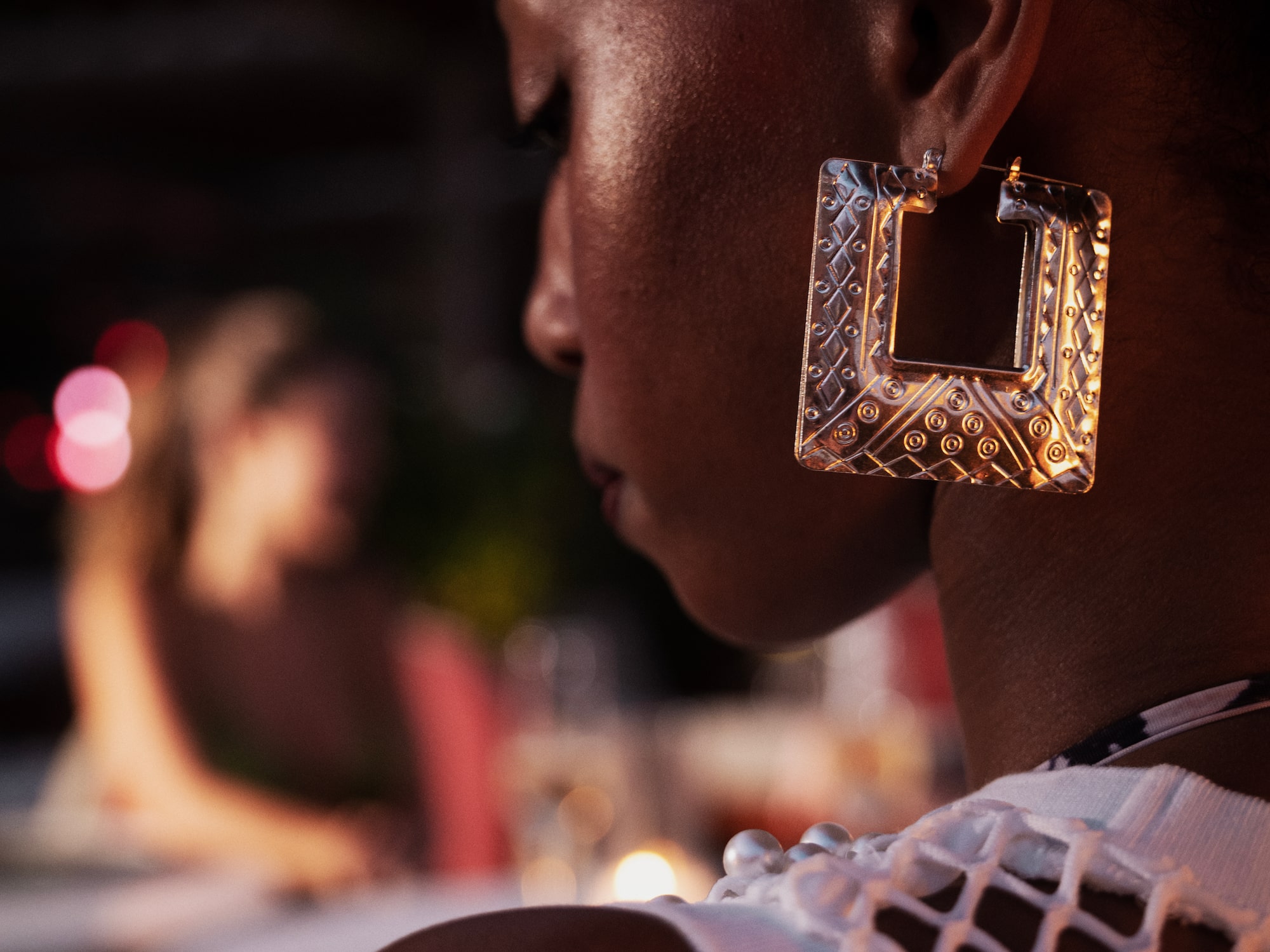 a woman wearing a large earrings