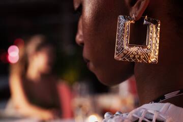 a woman wearing a large earrings