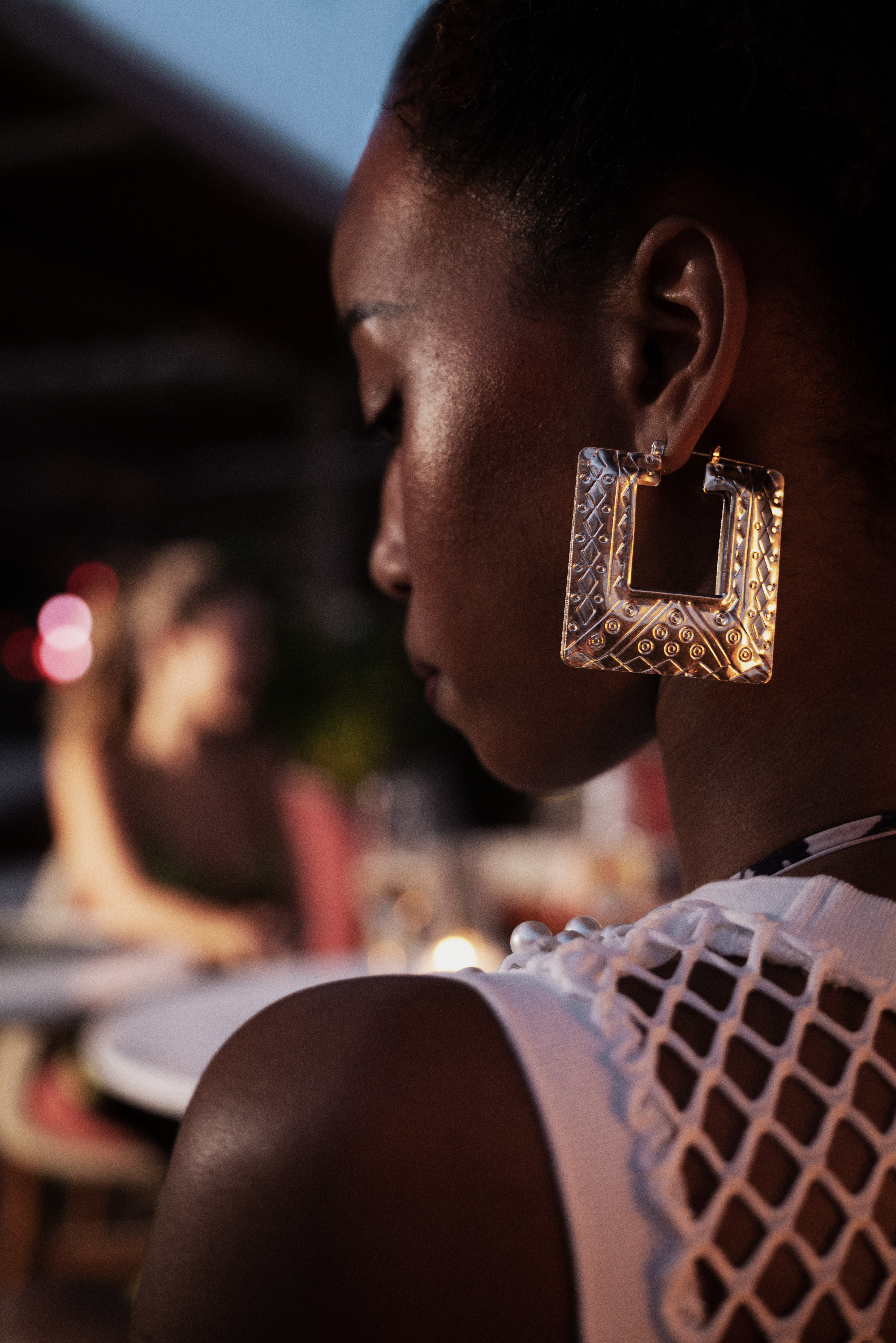 a woman wearing a large earrings