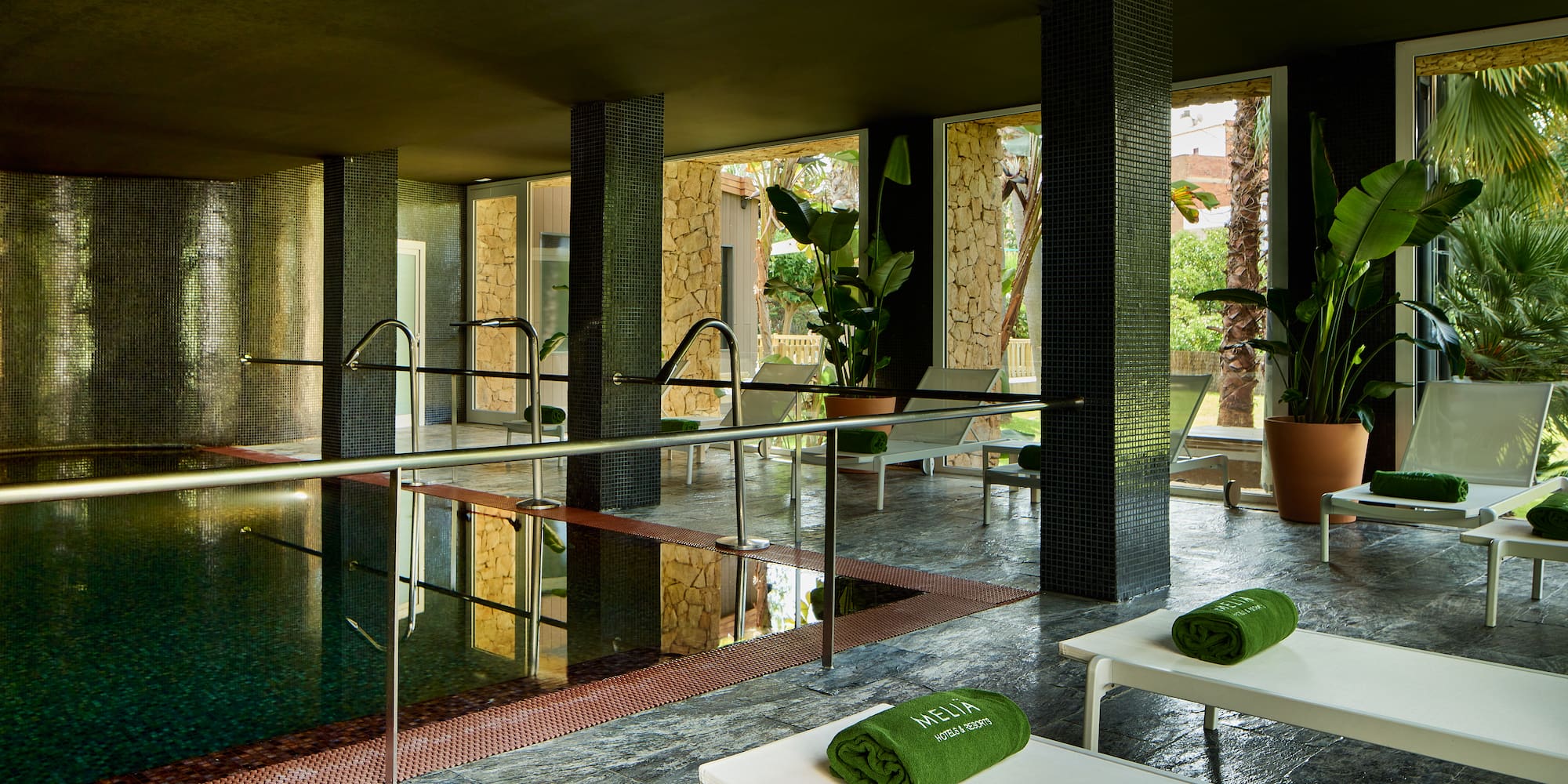 a pool with chairs and towels