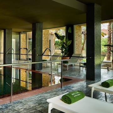 a pool with chairs and towels
