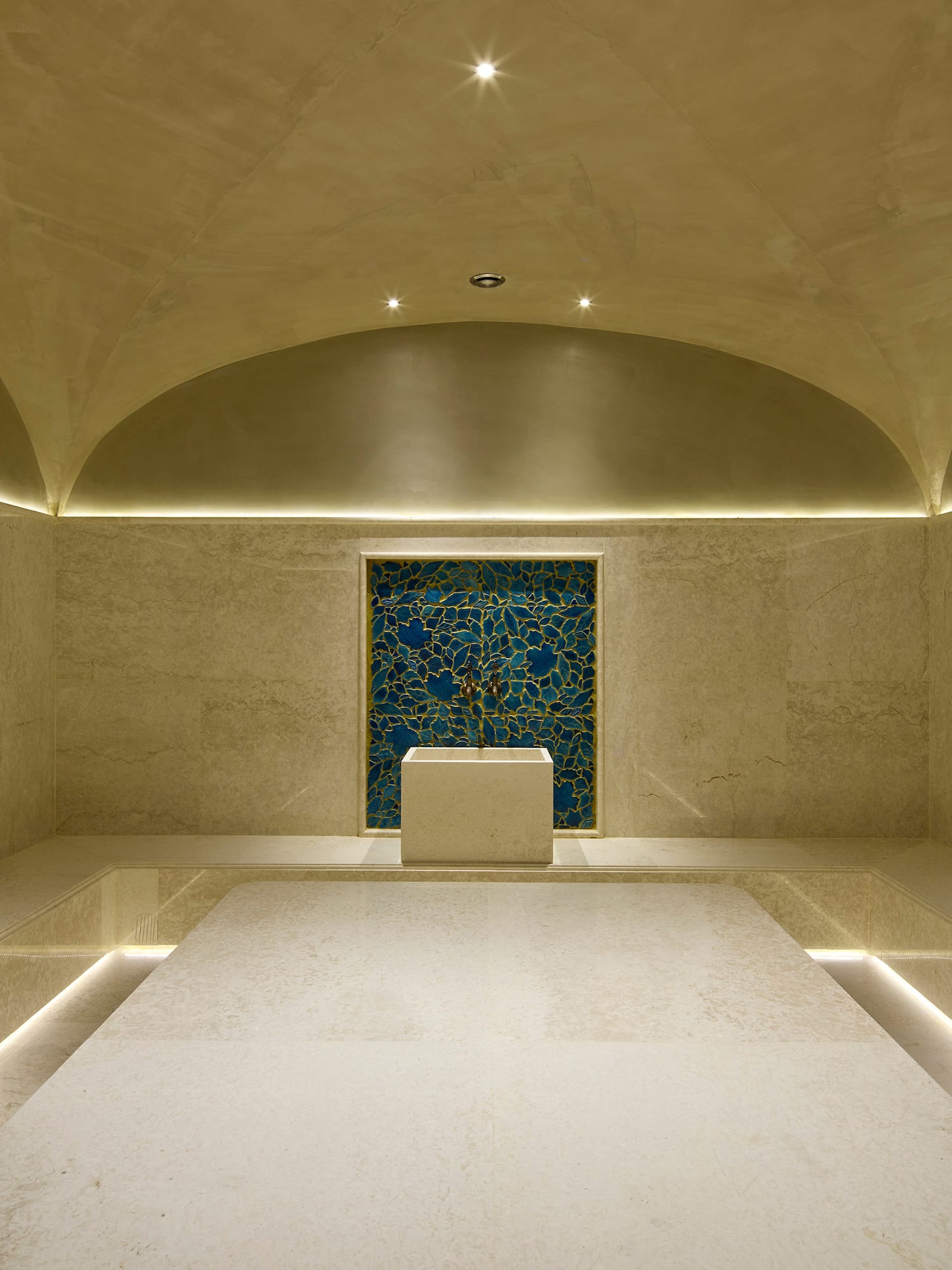 a room with a blue tile wall and a blue square wall