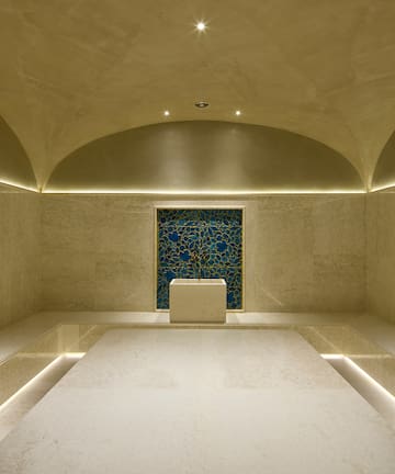 a room with a blue tile wall and a blue square wall