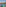 Aerial view of tropical luxury resort pool, palm trees, and ocean.