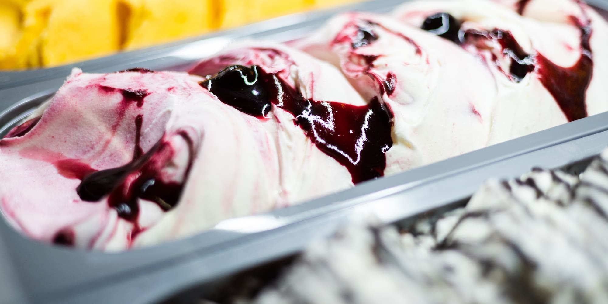 a tray of ice cream with fruit toppings