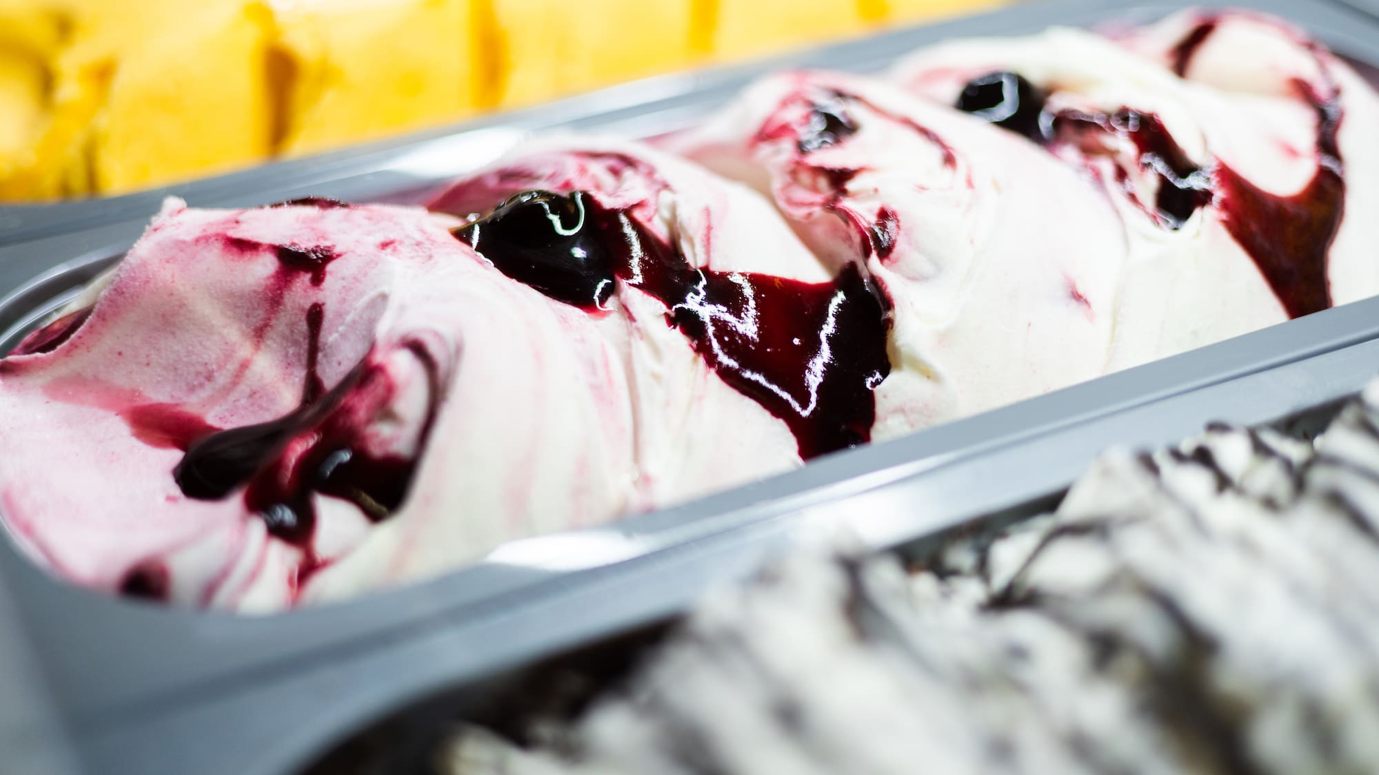 a tray of ice cream with fruit toppings