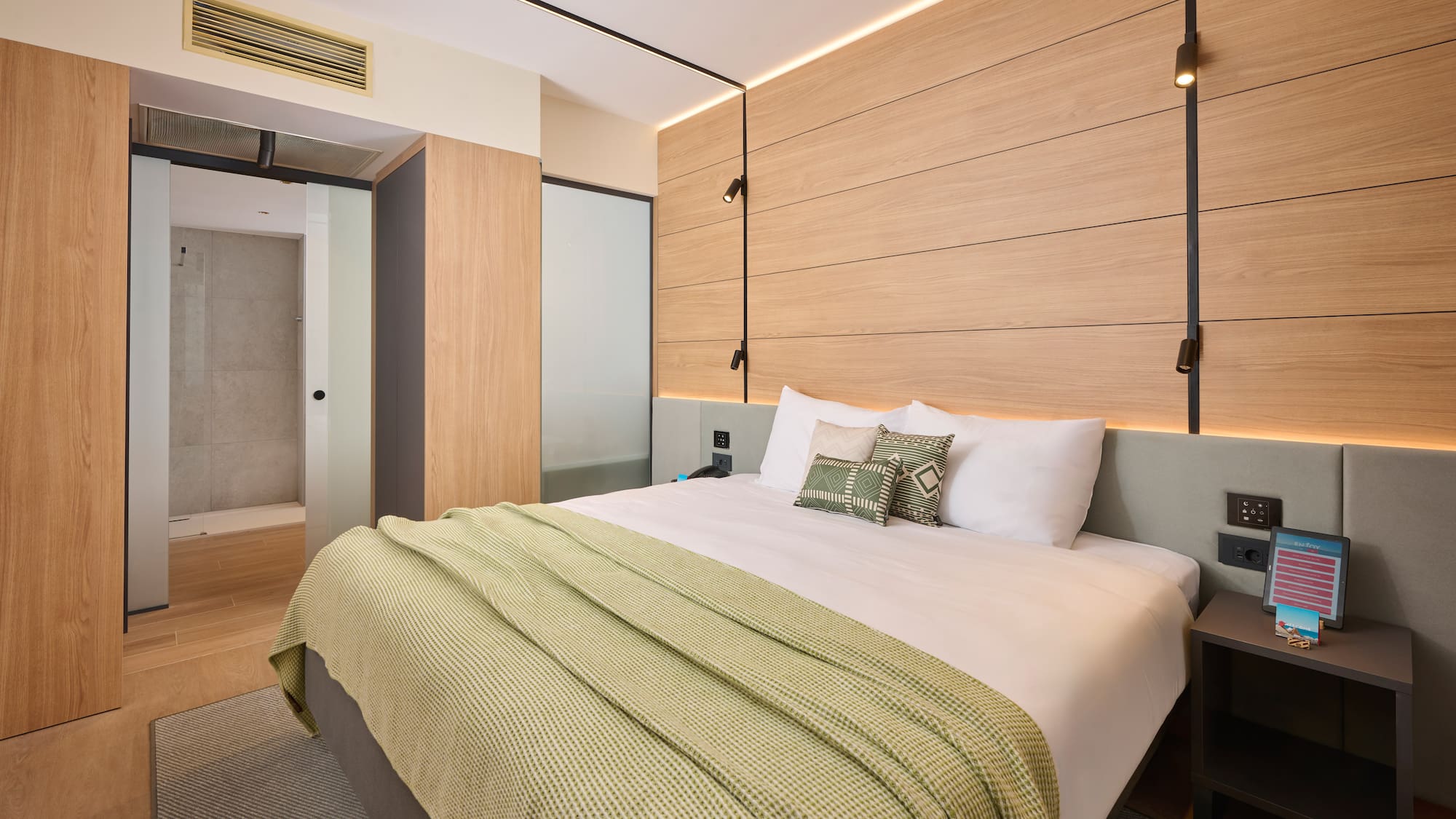 a bed with pillows and a bed with a wood paneled wall