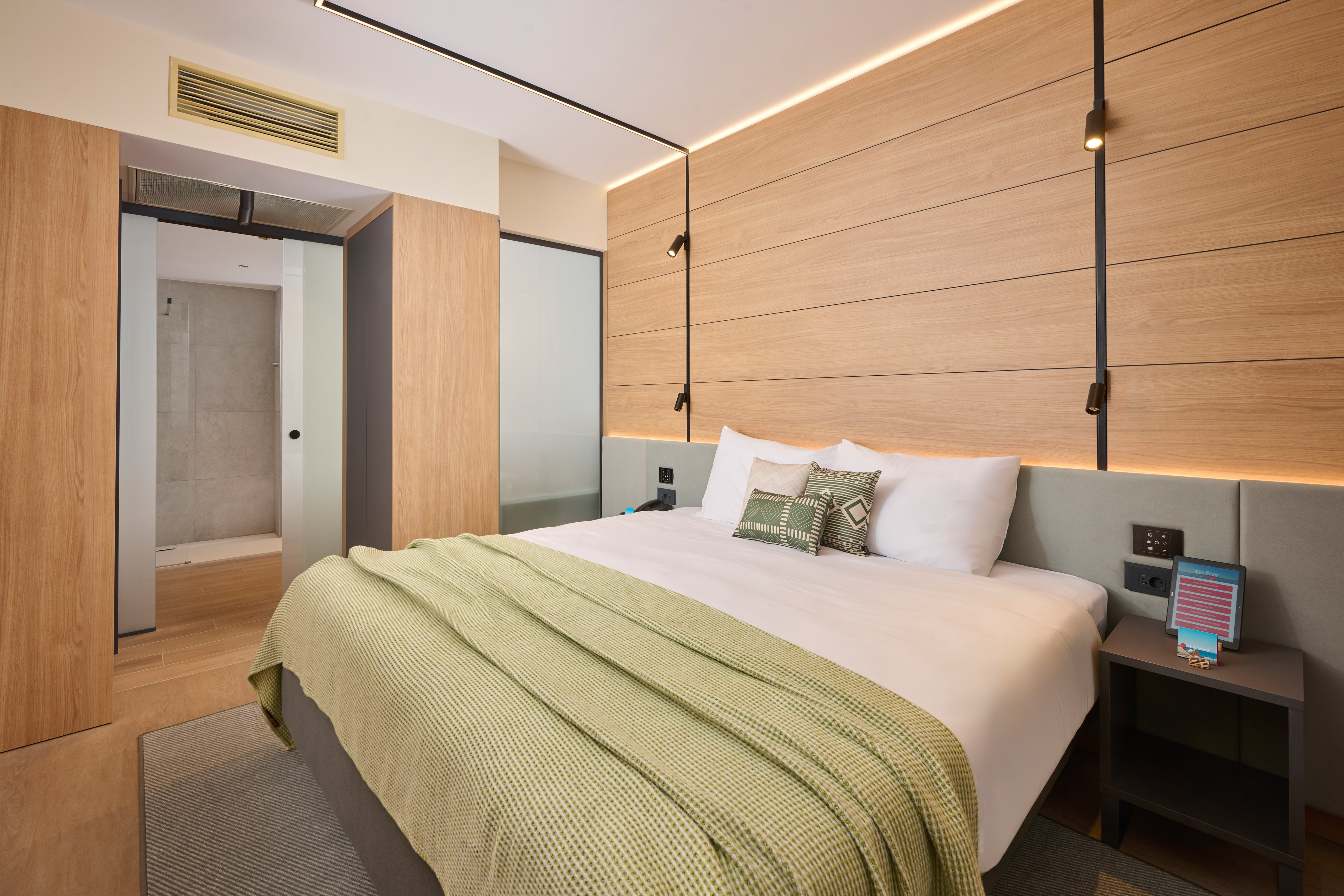 a bed with pillows and a bed with a wood paneled wall