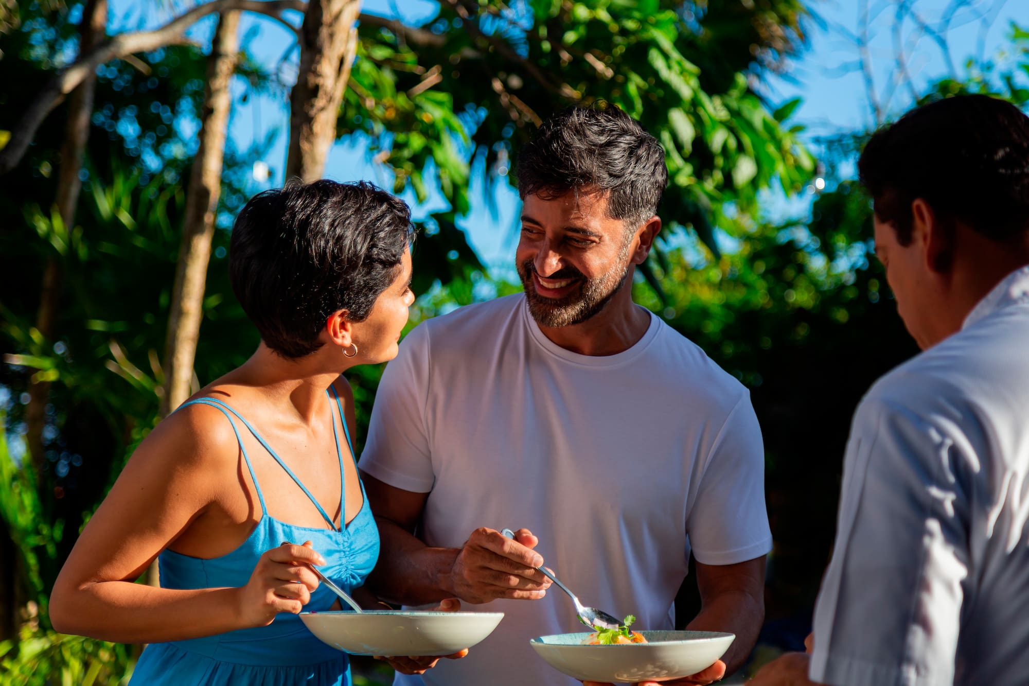 a man and woman smiling and eating food