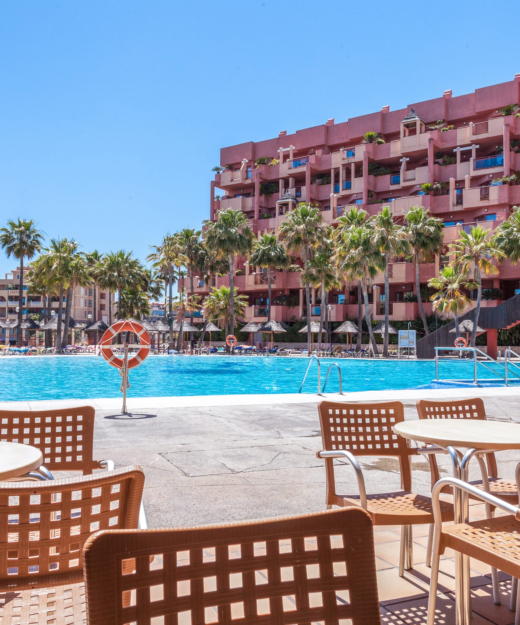 a pool with tables and chairs