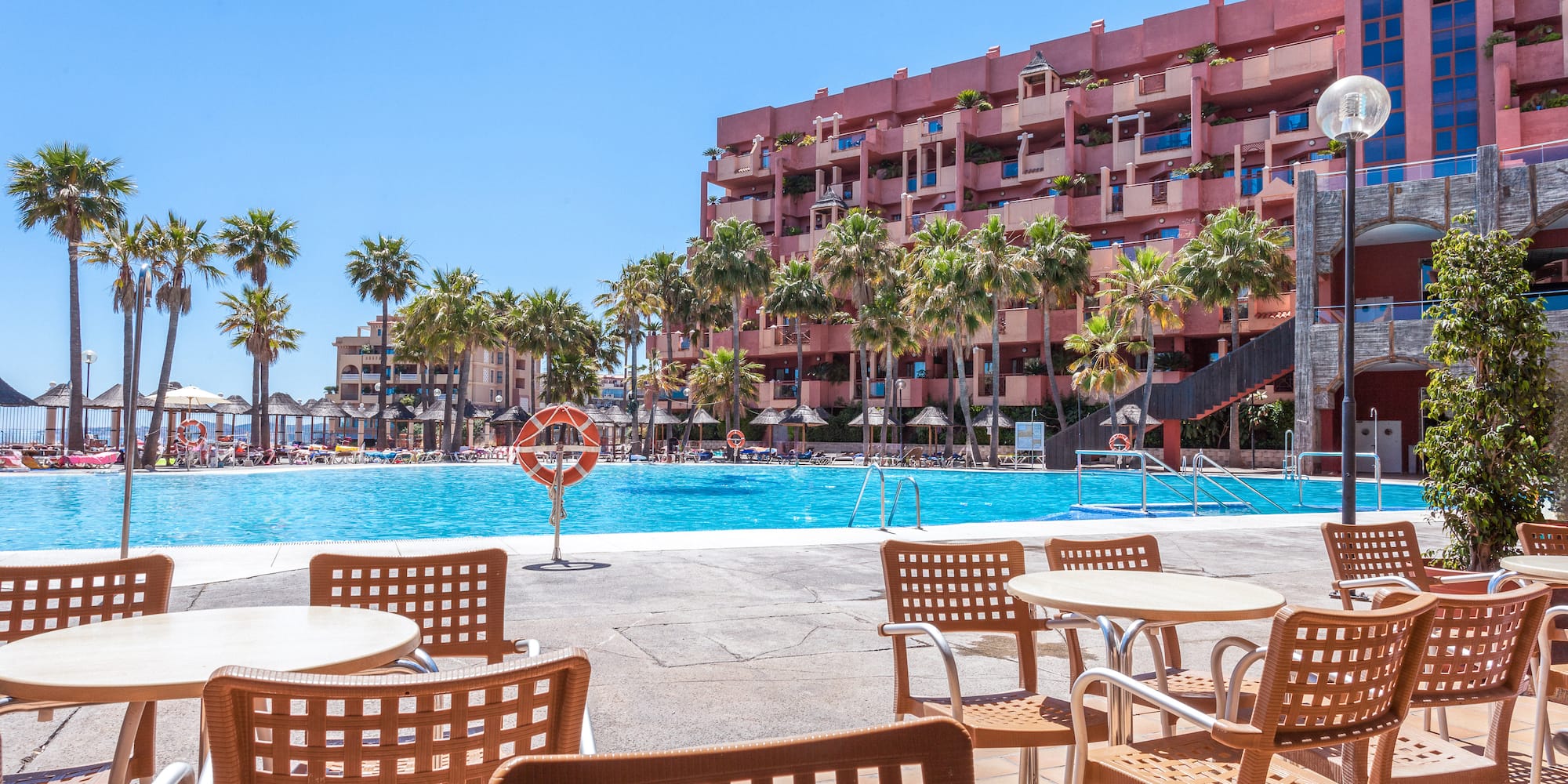 a pool with tables and chairs