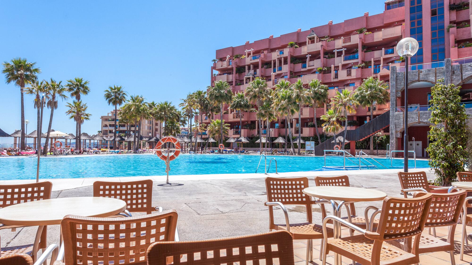 a pool with tables and chairs