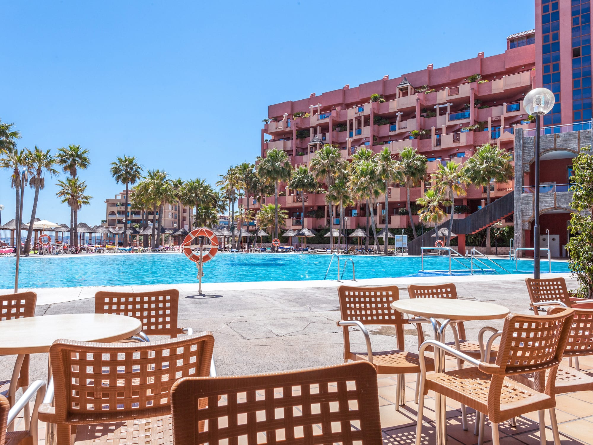 a pool with tables and chairs