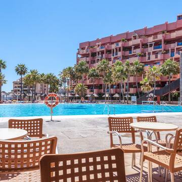 a pool with tables and chairs