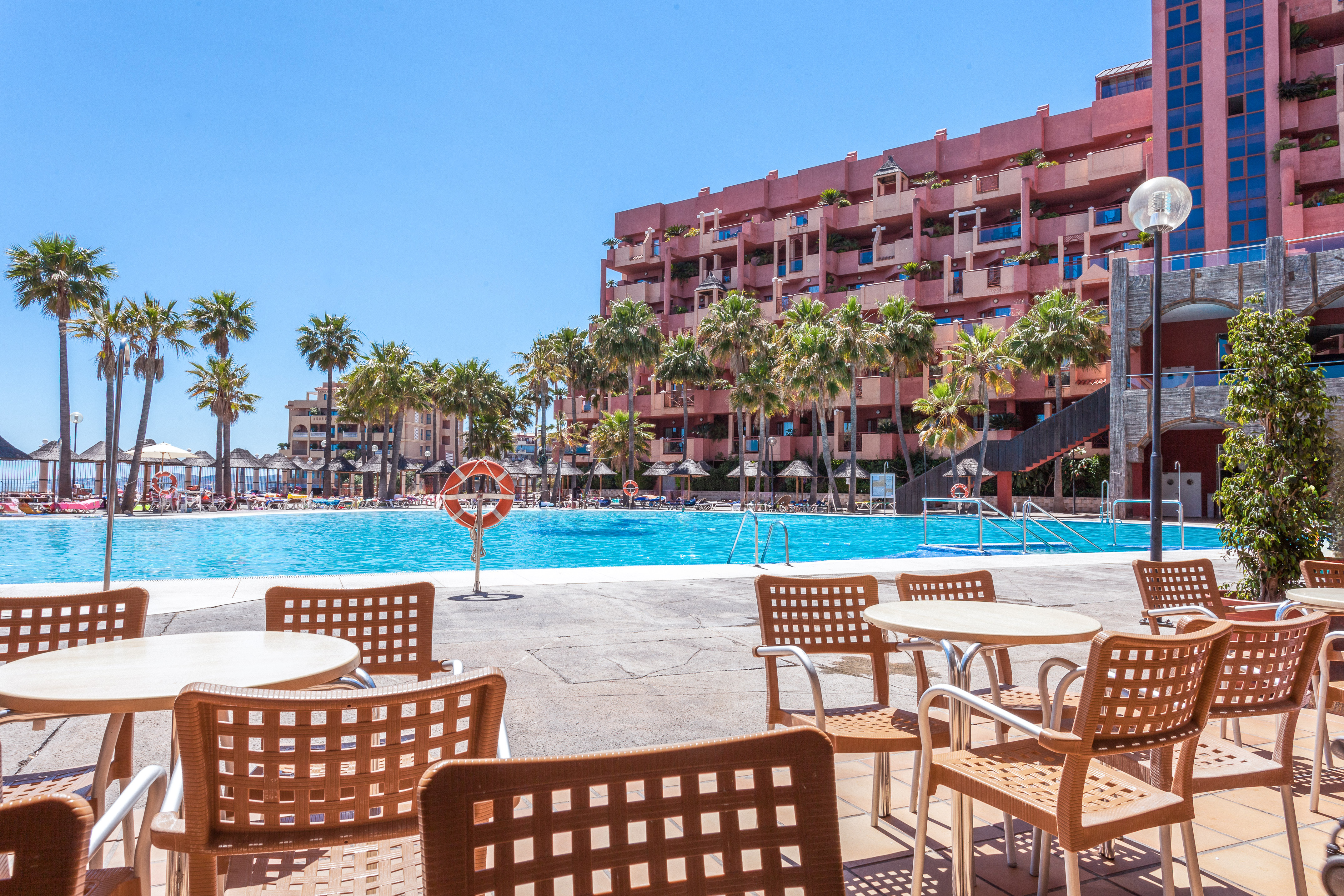 a pool with tables and chairs