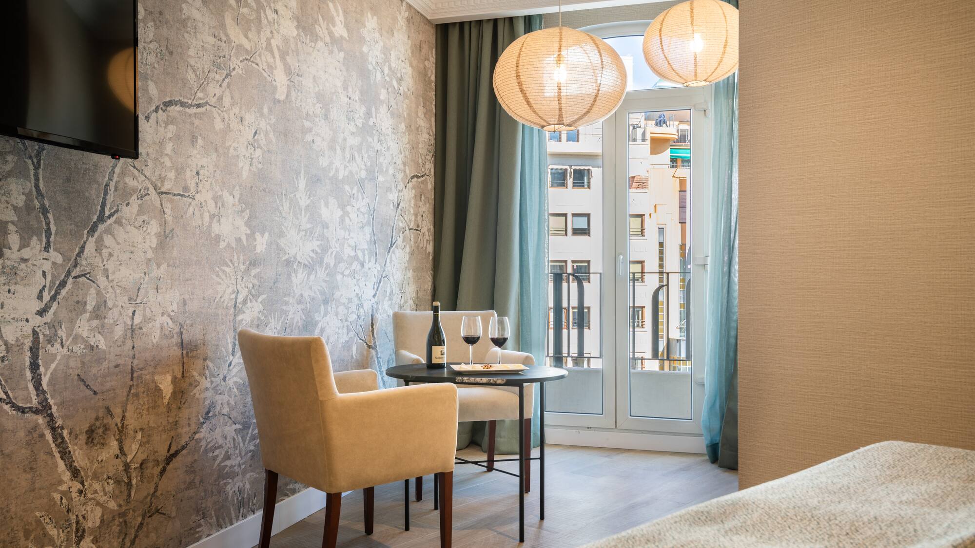 a room with a table and chairs and a table and a glass door