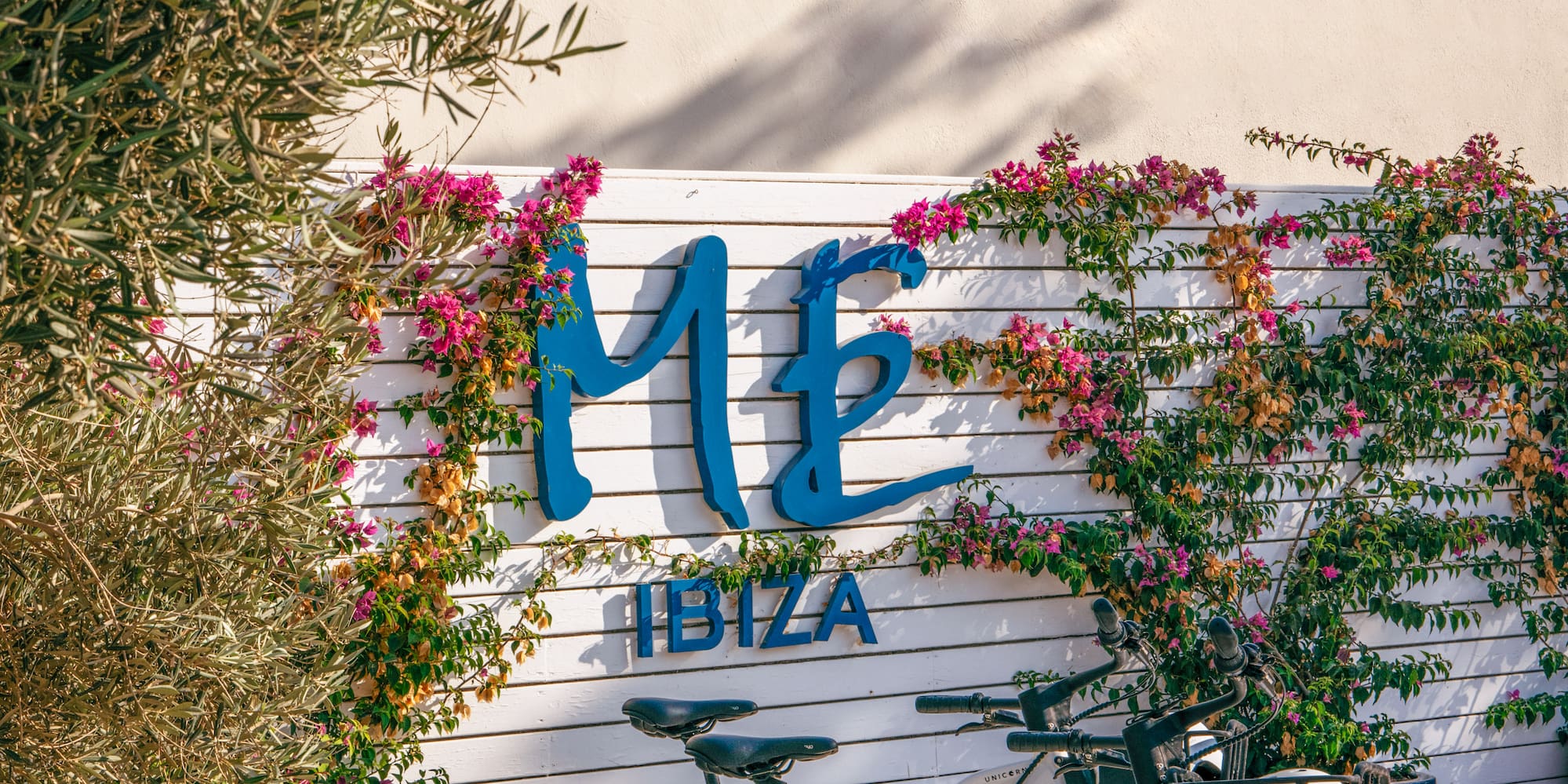a bicycle parked in front of a sign.