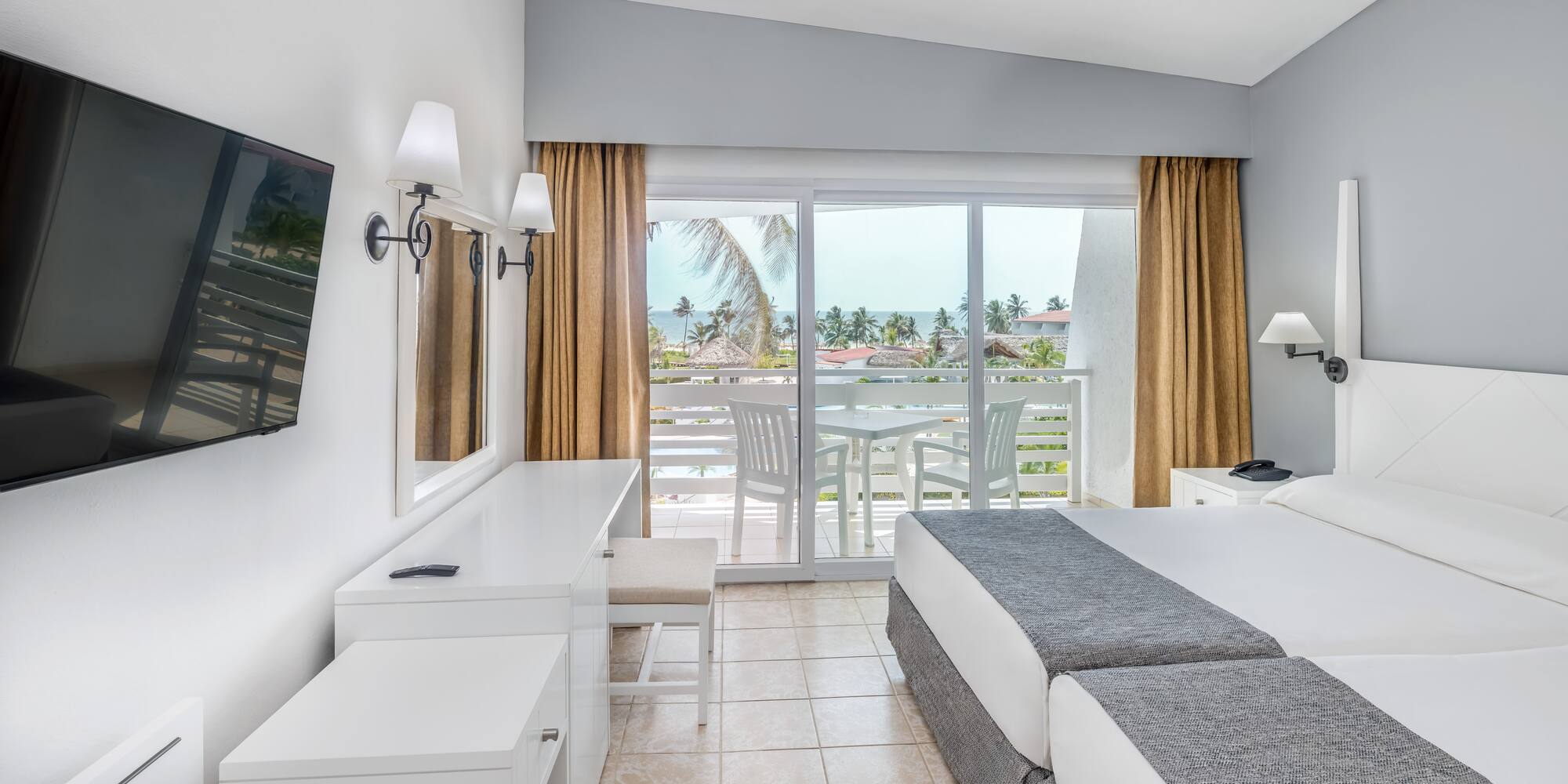 a room with a large bed and a television