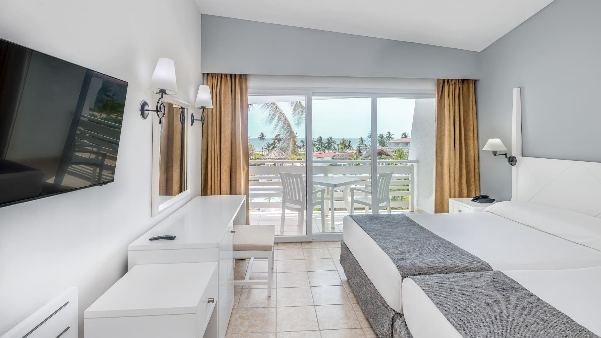 a room with a large bed and a television