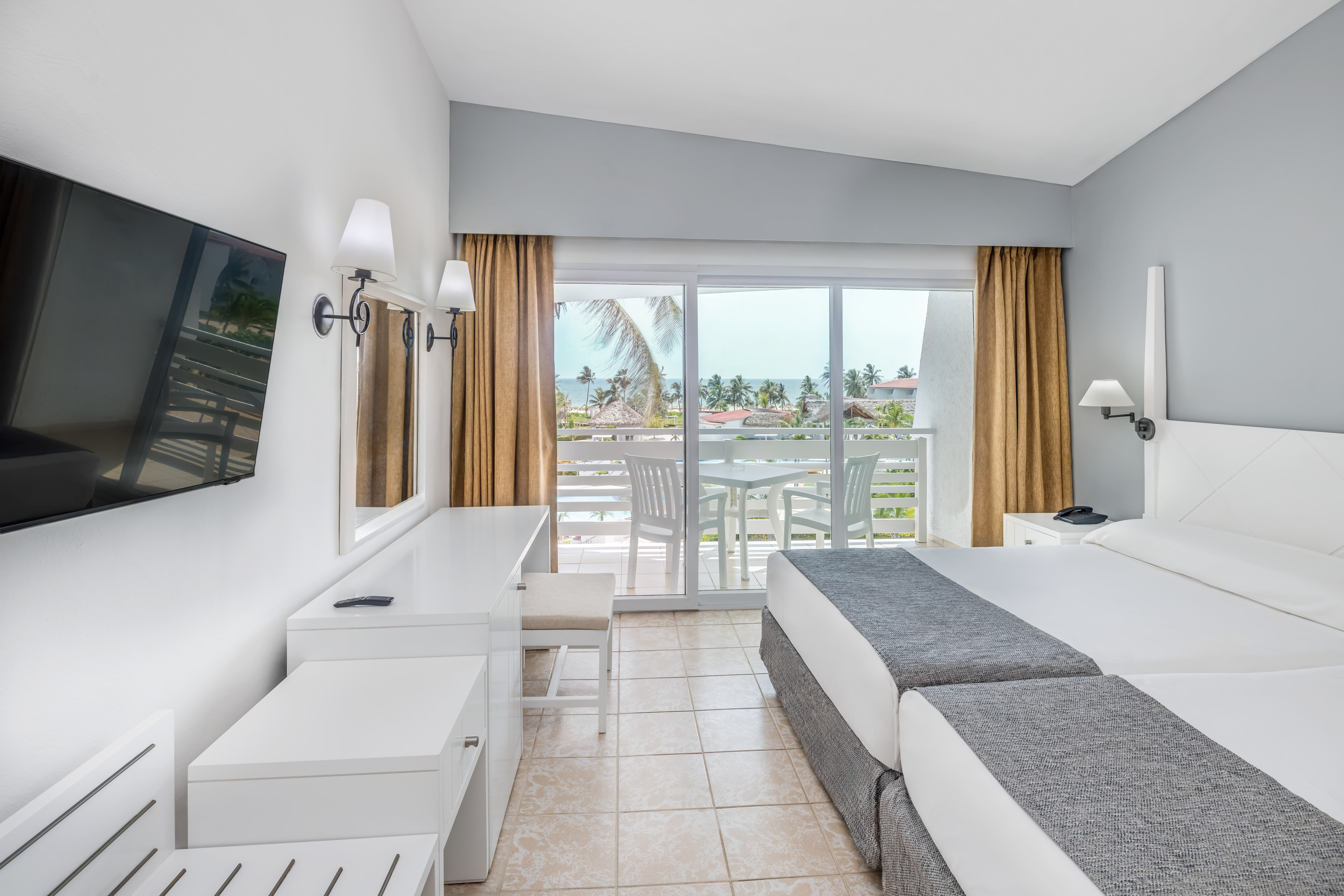 a room with a large bed and a television