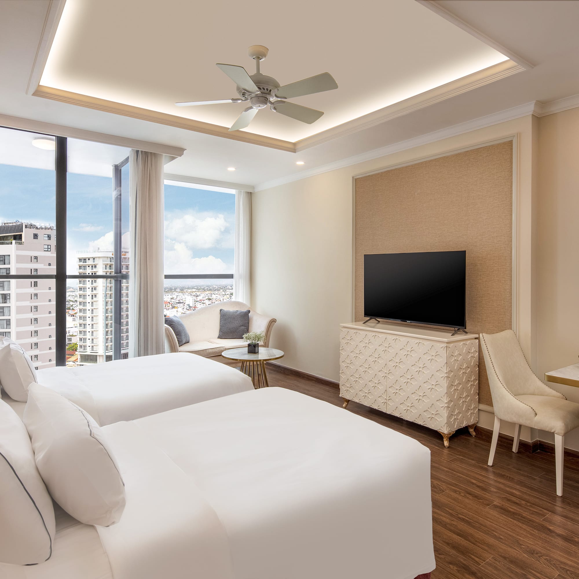 a room with two beds and a television