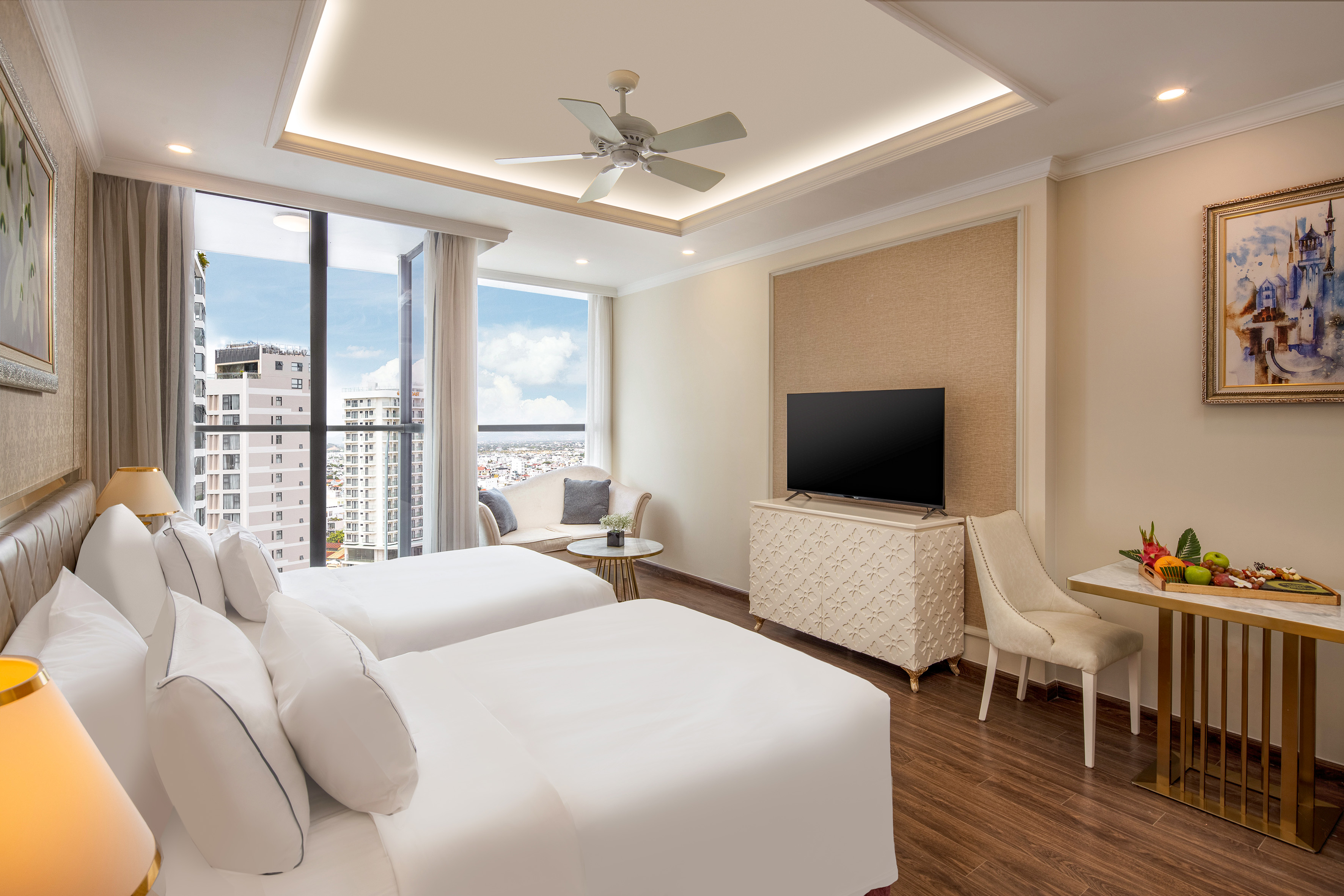 a room with two beds and a television