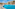 Resort swimming pool with hotel buildings, sun loungers, and clear blue sky.
