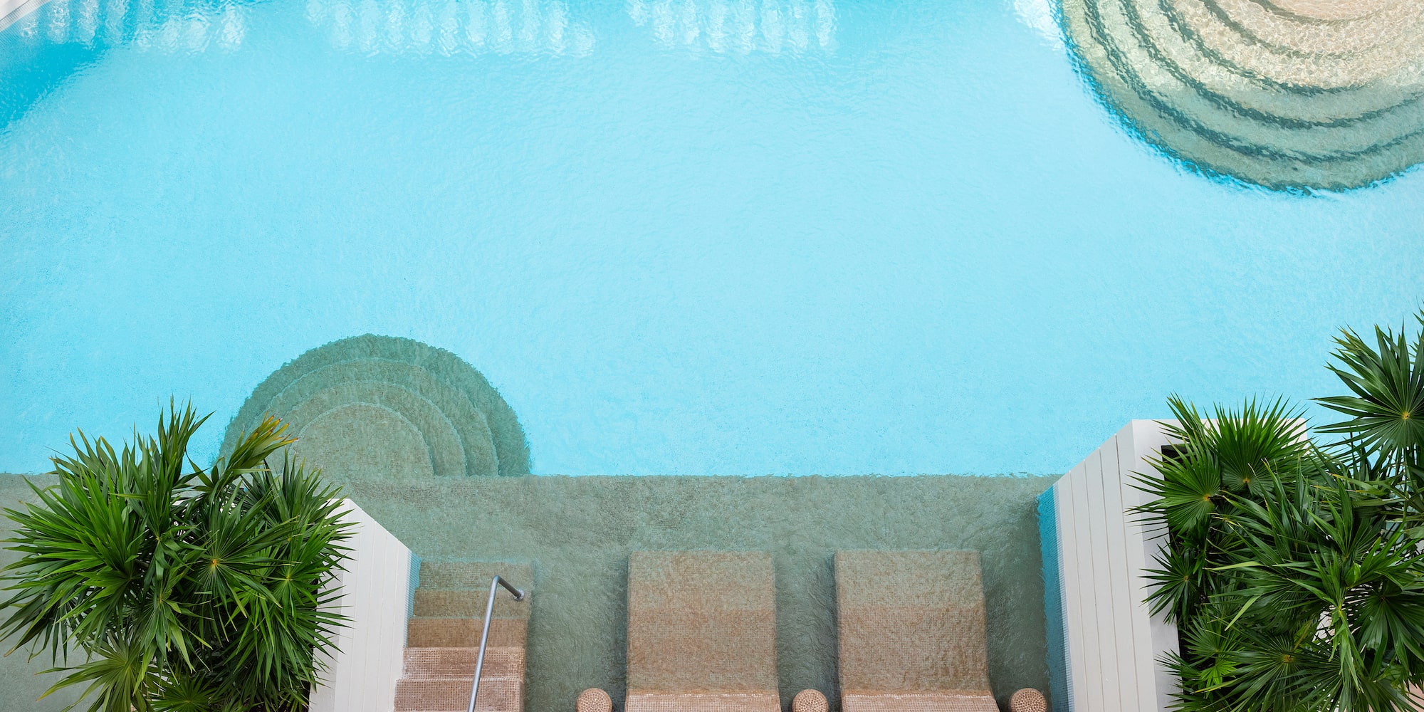 a swimming pool with steps and stairs