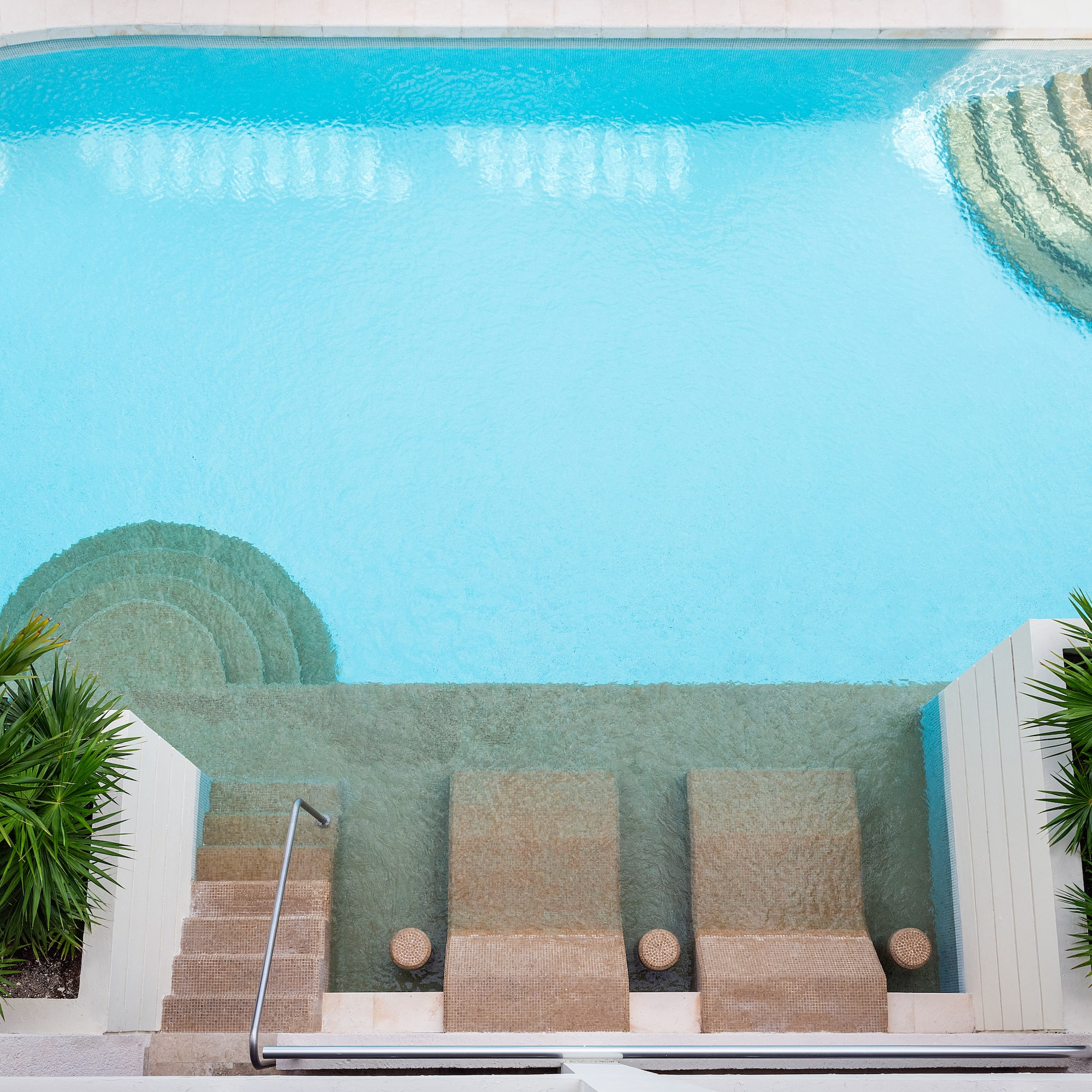 a swimming pool with steps and stairs