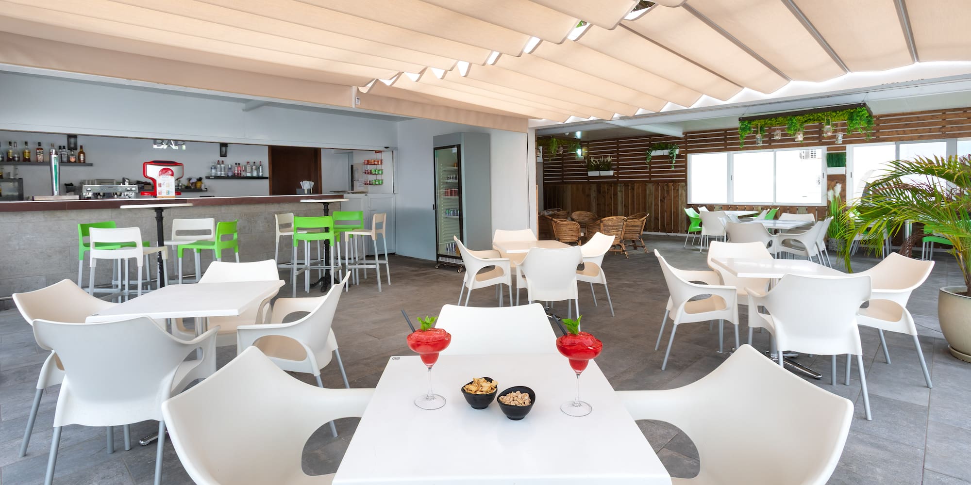 a room with tables and chairs and a bar