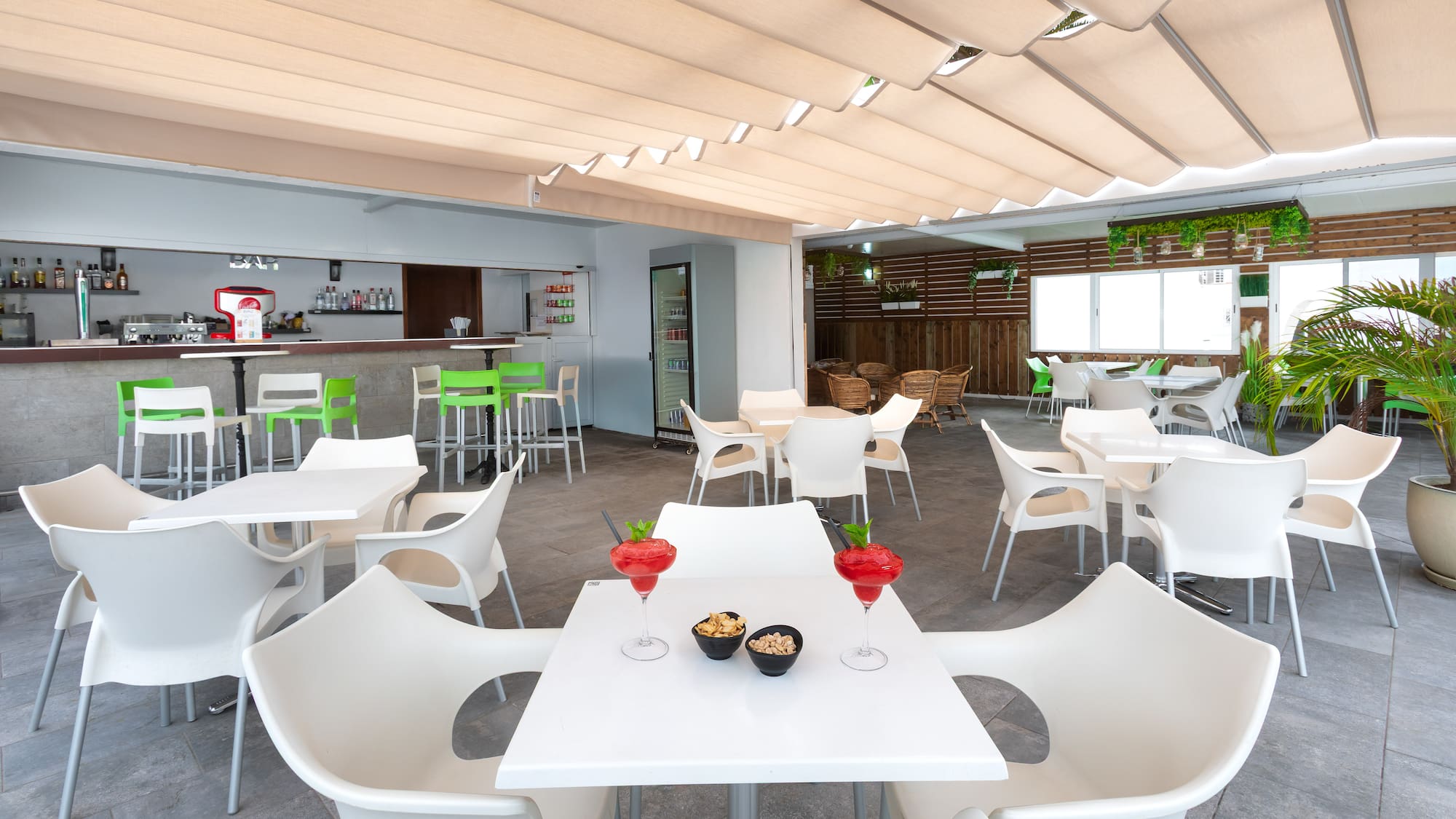 a room with tables and chairs and a bar